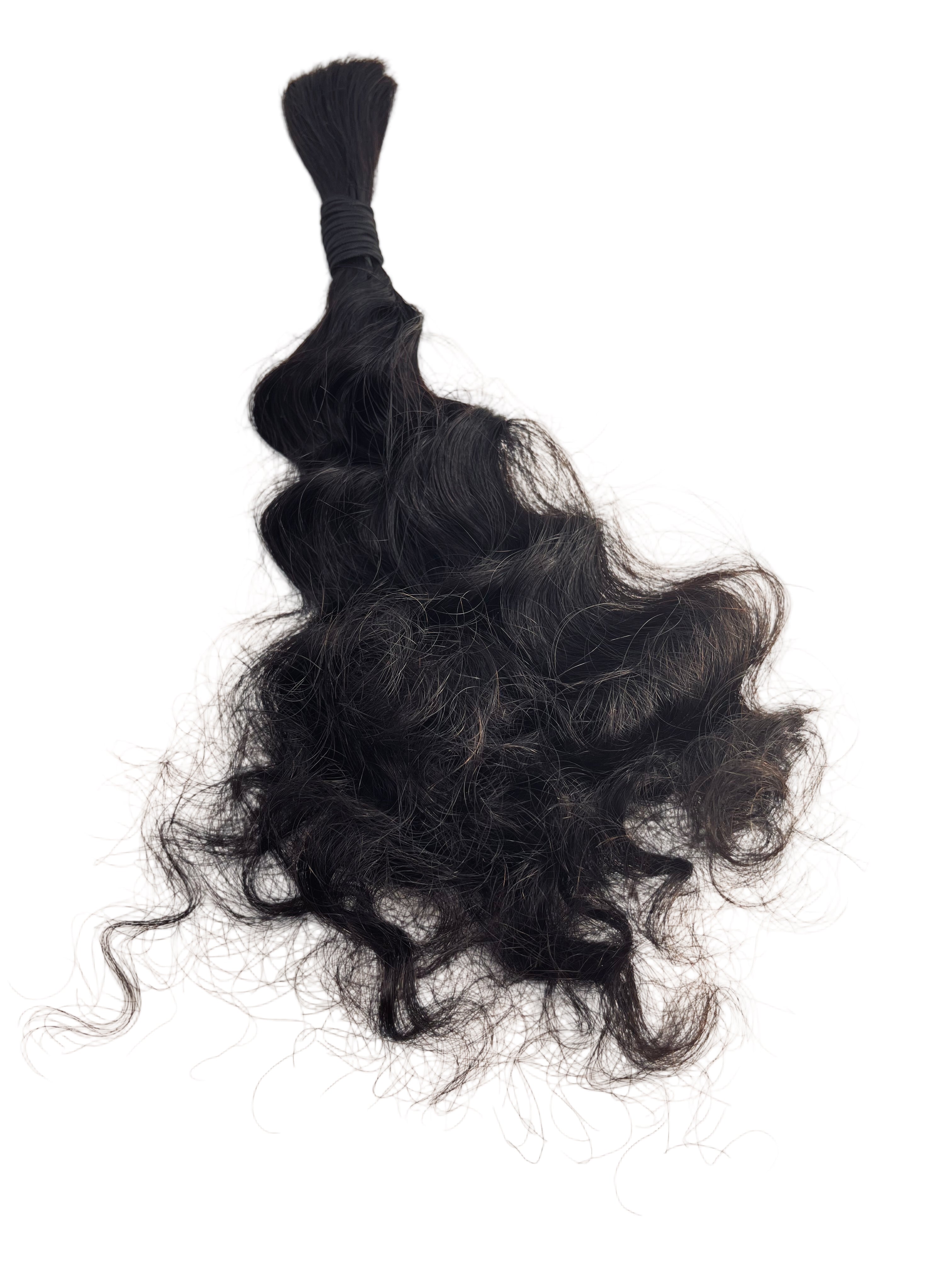 Bundled black hair extensions on a light beige background