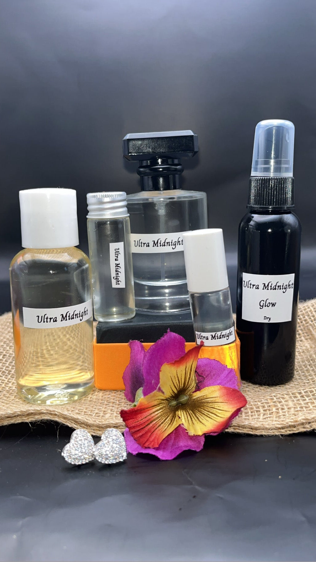 Collection of perfume bottles and accessories on a dark background