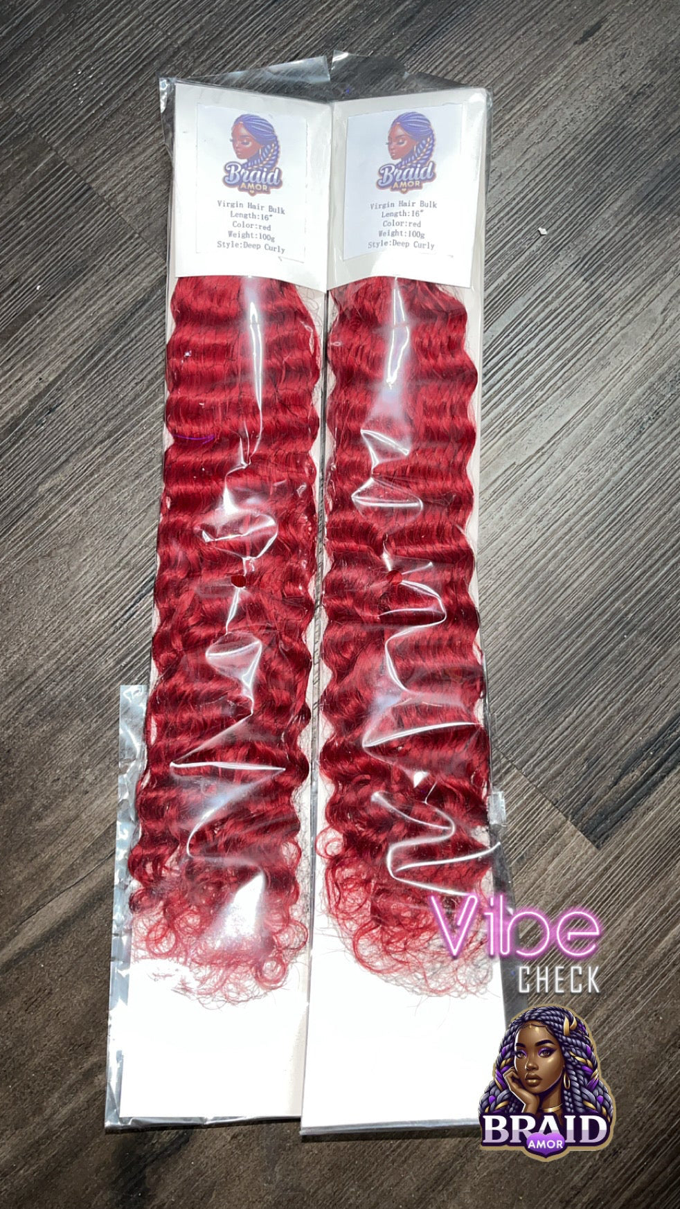 Red hair extensions in packaging on a wooden surface